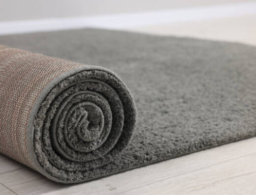 Rolled Grey Carpet On Floor In Room, Closeup