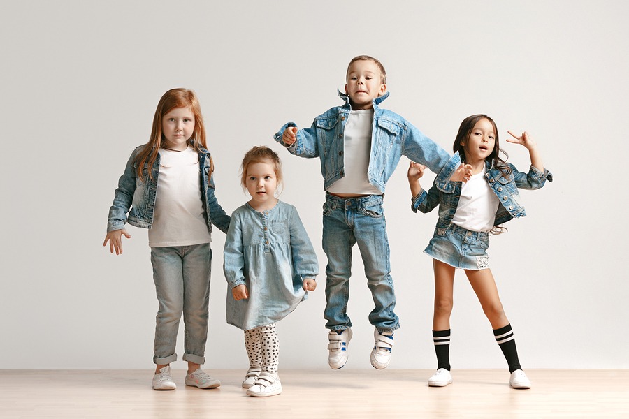 The portrait of cute little kids boy and girls in stylish jeans