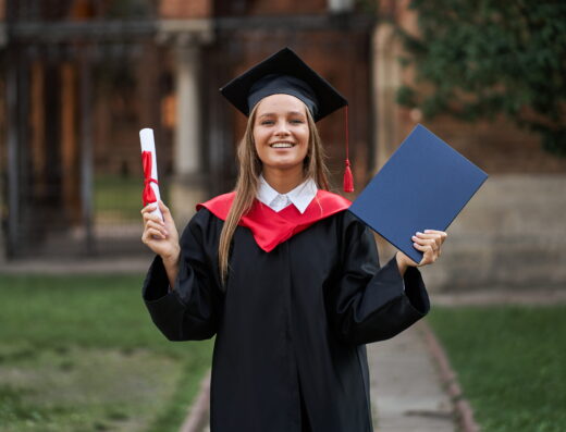 Female graduate graduation robe with diploma her hands campus (1)
